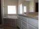 Bathroom featuring tub, vanity with white cabinets and granite countertops at 3020 Peggy Ave, Pahrump, NV 89048