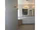Bathroom featuring tub, white cabinets, granite countertop and tiled floors at 3020 Peggy Ave, Pahrump, NV 89048