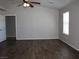 Bedroom features wood floors, a ceiling fan, natural light, and closet access, offering comfort and convenience at 3020 Peggy Ave, Pahrump, NV 89048