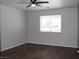 Bright bedroom features a ceiling fan, wood-look floors and a large window with bright light at 3020 Peggy Ave, Pahrump, NV 89048