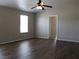 Inviting bedroom with wood floors, a ceiling fan, and natural light creating a comfortable and relaxing space at 3020 Peggy Ave, Pahrump, NV 89048