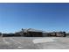 Wide shot of desert home featuring a tile roof, gravel landscaping, and a large RV parked on the side at 3020 Peggy Ave, Pahrump, NV 89048