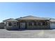 Attractive front exterior featuring a tile roof, double-door entry, and desert landscaping at 3020 Peggy Ave, Pahrump, NV 89048
