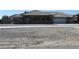 Sprawling single-story home with a large driveway, desert landscaping, and a tile roof at 3020 Peggy Ave, Pahrump, NV 89048