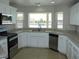 Charming kitchen features ample counter space, white cabinets, stainless steel appliances and a bright window at 3020 Peggy Ave, Pahrump, NV 89048