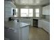 Modern kitchen boasts white cabinets, stainless steel appliances, tile countertops, and a bright, airy feel at 3020 Peggy Ave, Pahrump, NV 89048