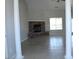 Open living room featuring a stone fireplace, tile flooring, and a large bright window at 3020 Peggy Ave, Pahrump, NV 89048