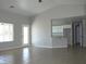Bright living room boasts tile flooring, a large window, and access to the kitchen for easy entertaining at 3020 Peggy Ave, Pahrump, NV 89048