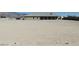 Flat and expansive desert lot with single-story house and mature trees at 3020 Peggy Ave, Pahrump, NV 89048