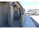 Side view of the home showing the covered front porch, decorative lights, and the RV parking area at 3020 Peggy Ave, Pahrump, NV 89048