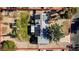 An aerial view of a home featuring a solar-paneled roof, established trees, fenced yard and long driveway at 3100 Garehime St, Las Vegas, NV 89108