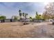 Expansive backyard featuring a greenhouse, mature trees, and plenty of space for outdoor activities and potential landscaping at 3100 Garehime St, Las Vegas, NV 89108