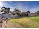 Well-maintained backyard with lush grass, mature trees, and landscaped flower beds at 3100 Garehime St, Las Vegas, NV 89108