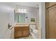 Bathroom featuring a mirrored wall, tiled walls, vanity sink, and a toilet at 3100 Garehime St, Las Vegas, NV 89108