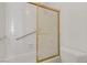 Bathroom featuring a bathtub with sliding glass door and accessibility bar at 3100 Garehime St, Las Vegas, NV 89108