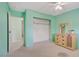 Cozy bedroom featuring green walls, carpet flooring, ceiling fan, and a closet at 3100 Garehime St, Las Vegas, NV 89108