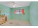 Cozy bedroom featuring green walls, carpet flooring, ceiling fan, and a window at 3100 Garehime St, Las Vegas, NV 89108