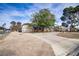 Charming home featuring a spacious driveway, attached garage, and mature trees at 3100 Garehime St, Las Vegas, NV 89108