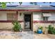Close up of home entrance featuring mature landscaping, secure entry door, and charming details at 3100 Garehime St, Las Vegas, NV 89108