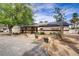 Charming home exterior with gravel driveway, solar panels, and drought-tolerant landscaping at 3100 Garehime St, Las Vegas, NV 89108