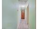 Hallway featuring light green walls, wood cabinets, and wood flooring at 3100 Garehime St, Las Vegas, NV 89108