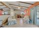 Open living room with beamed ceiling, tile flooring, seating, and a built-in desk area at 3100 Garehime St, Las Vegas, NV 89108