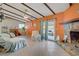 Spacious living room with beamed ceilings, stone fireplace, and sliding glass doors at 3100 Garehime St, Las Vegas, NV 89108