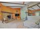 Living room featuring a stone fireplace, tiled floor, and ample natural light at 3100 Garehime St, Las Vegas, NV 89108