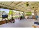 Spacious covered patio with seating, a grill, and views of the backyard, perfect for outdoor entertaining at 3100 Garehime St, Las Vegas, NV 89108