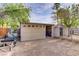 Spacious garage and storage shed in backyard, featuring a secure garage door and a fenced entrance at 3100 Garehime St, Las Vegas, NV 89108