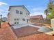 An expansive backyard features a concrete patio and simple xeriscaping for easy maintenance at 3444 Trilogy Dr, Las Vegas, NV 89108