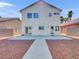 An expansive backyard features a concrete patio and simple xeriscaping for easy maintenance at 3444 Trilogy Dr, Las Vegas, NV 89108