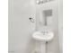 Elegant pedestal sink and mirrored vanity in this well-lit, minimalist powder room at 3444 Trilogy Dr, Las Vegas, NV 89108