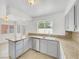 Kitchen with grey cabinets and granite countertops with a stainless steel dishwasher and sink at 3444 Trilogy Dr, Las Vegas, NV 89108