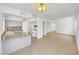Spacious kitchen with grey cabinets and granite countertops open to living area at 3444 Trilogy Dr, Las Vegas, NV 89108