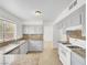 The kitchen has grey cabinets and granite countertops with a window overlooking the front yard at 3444 Trilogy Dr, Las Vegas, NV 89108