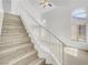 Bright and airy staircase featuring wood treads, white risers, and ample natural light at 3444 Trilogy Dr, Las Vegas, NV 89108
