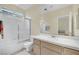 Bright bathroom with shower-tub combo, single sink vanity with white countertop, and a large mirror at 3755 Broadmead St, Las Vegas, NV 89147