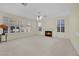 Cozy living room with fireplace, ceiling fan, and large windows at 3755 Broadmead St, Las Vegas, NV 89147