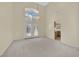 Bright, open-concept living room with French doors and neutral carpet at 3755 Broadmead St, Las Vegas, NV 89147