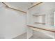 Spacious walk-in closet with custom shelving and wooden bars for organized storage at 3755 Broadmead St, Las Vegas, NV 89147