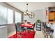 Bright dining room with ample natural light, complemented by a stylish chandelier and adjacent kitchen bar seating at 3840 Belle Glade St # 104, Las Vegas, NV 89129