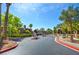 Gated community entrance featuring landscaping and multi-unit architecture in background at 3840 Belle Glade St # 104, Las Vegas, NV 89129