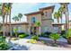 Community clubhouse showcasing entrance, landscaping, mature palm trees, and architectural details at 3840 Belle Glade St # 104, Las Vegas, NV 89129