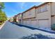 Multi-unit building with multiple garages showcasing architecture against a clear sky backdrop at 3840 Belle Glade St # 104, Las Vegas, NV 89129