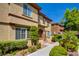 Inviting two-story townhome with manicured landscaping, a charming front entrance, and a cozy patio area at 3840 Belle Glade St # 104, Las Vegas, NV 89129