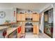 Bright kitchen features stainless steel appliances, tile flooring, and wood cabinetry at 3840 Belle Glade St # 104, Las Vegas, NV 89129