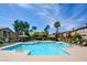 Community pool surrounded by lounge chairs, shade structures and manicured landscape at 3840 Belle Glade St # 104, Las Vegas, NV 89129