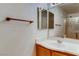 Well-lit bathroom boasts a mirrored vanity, a shower and decorative towel holder at 447 Temple Canyon Pl, Henderson, NV 89074