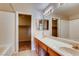 Bright bathroom featuring a dual sink vanity with tile flooring, a shower and walk-in closet at 447 Temple Canyon Pl, Henderson, NV 89074